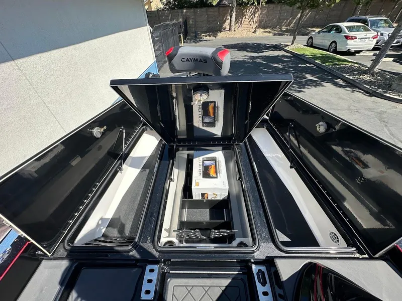 Slide: The Image of 2024 Caymas XS 20 Pro boat storage compartments open, showcasing interior layout. - 29
