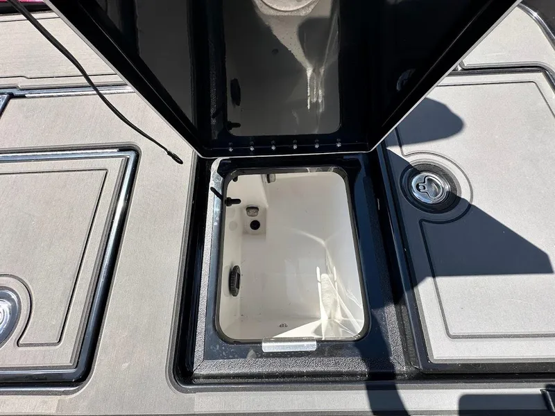 Slide: The Image of Open storage compartment on 2024 Caymas XS 20 Pro boat deck. - 31