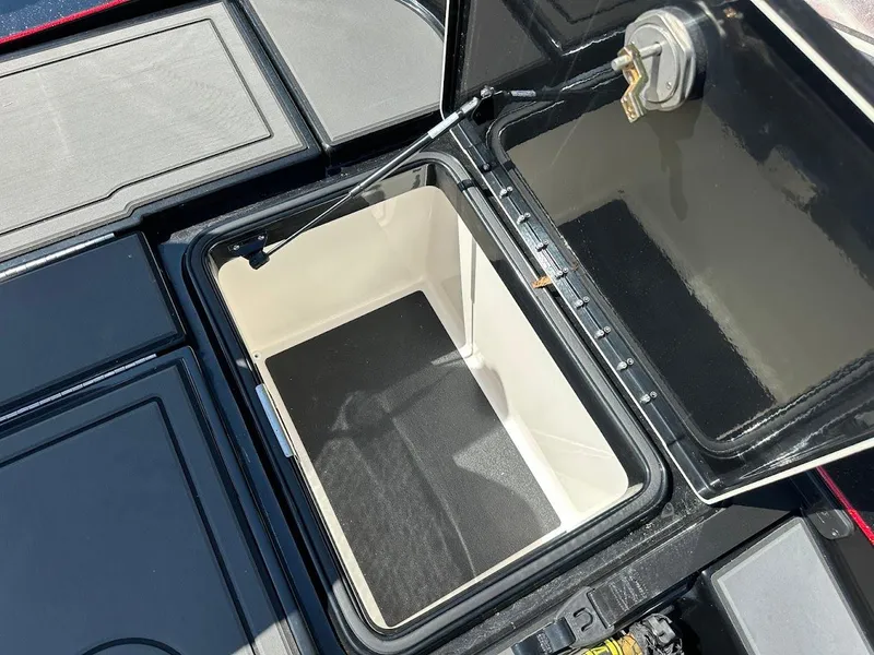 Slide: The Image of 2024 Caymas XS 20 Pro boat storage compartment with open lid, showcasing interior space. - 32