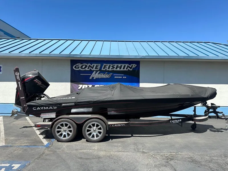 Slide: The Image of 2024 Caymas XS 20 Pro boat with cover on trailer, parked outside dealership. - 33