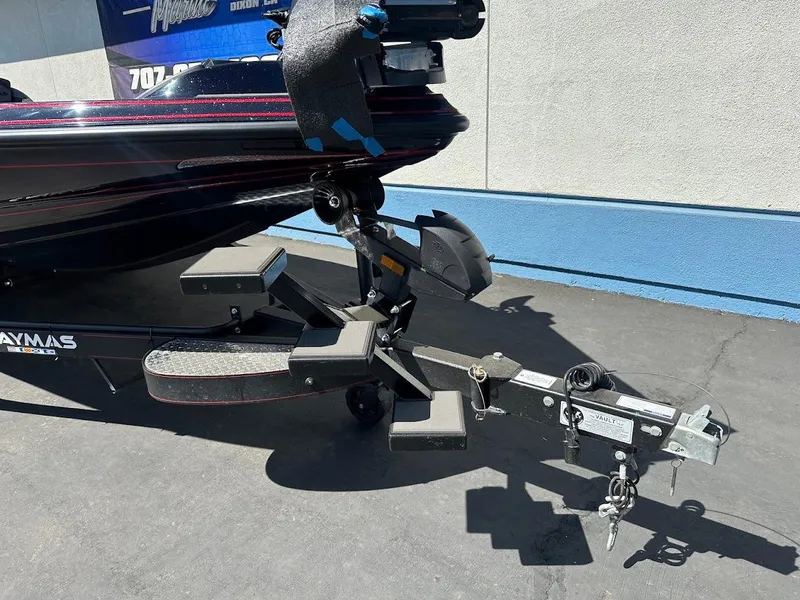 Slide: The Image of 2024 Caymas XS 20 Pro boat trailer hitch and steps, parked on pavement. - 4