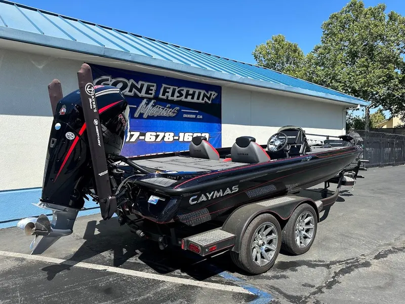 Slide: The Image of 2024 Caymas XS 20 Pro boat parked outside a marine shop on a sunny day. - 8