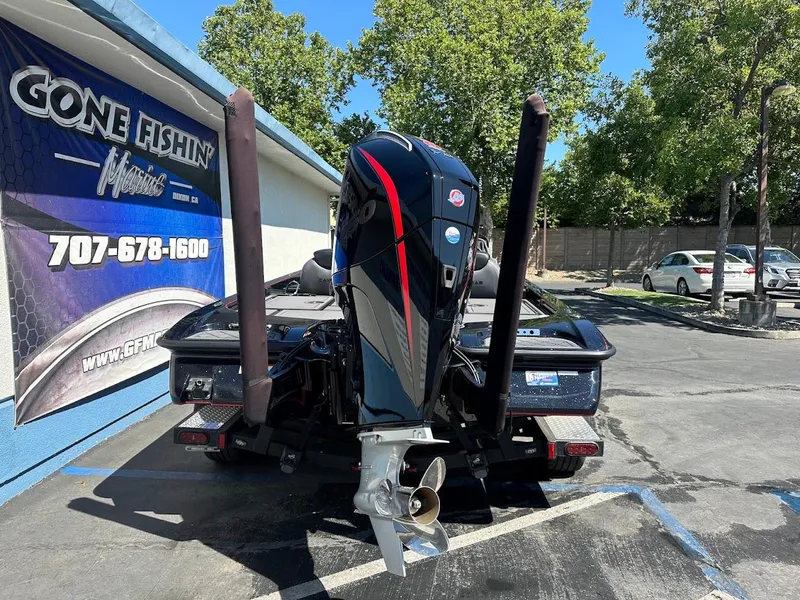 Slide: The Image of 2024 Caymas XS 20 Pro boat with powerful outboard motor, parked at dealership. - 9