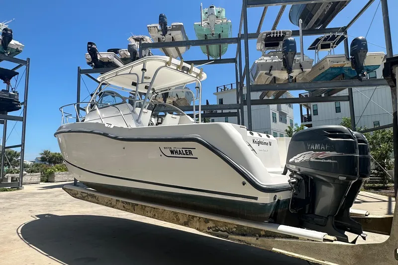 Slide: The Image of 2002 Boston Whaler 255 Conquest boat with Yamaha engine on dry dock. - 3