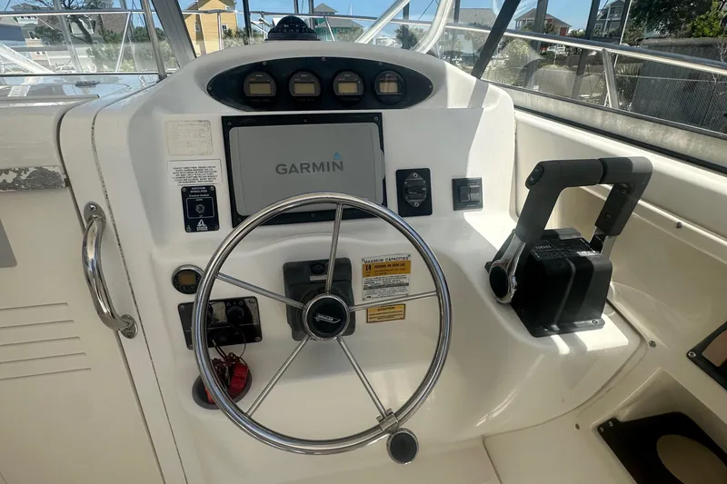 Slide: The Image of Boston Whaler 255 Conquest 2002 helm with Garmin navigation and steering wheel. - 6