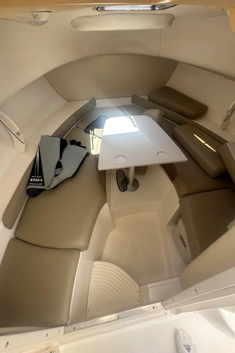 Slide: The Image of 2002 Boston Whaler 255 Conquest cabin interior with seating and table. - 7