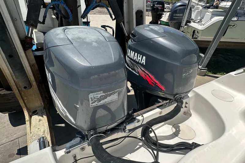 Slide: The Image of Twin Yamaha outboard engines on a 2002 Boston Whaler 255 Conquest boat. - 8