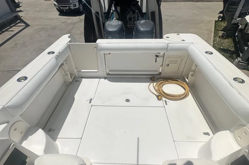 Slide: The Image of 2002 Boston Whaler 255 Conquest boat deck with seating and coiled rope. - 9