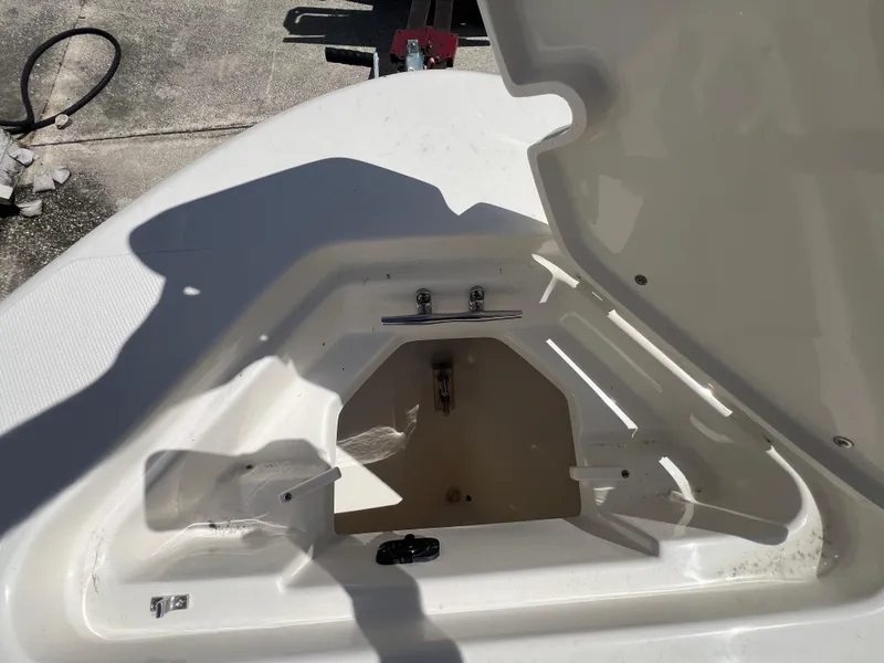 Slide: The Image of Open storage compartment on a 2026 Pioneer 180 Islander boat, showing interior details. - 20