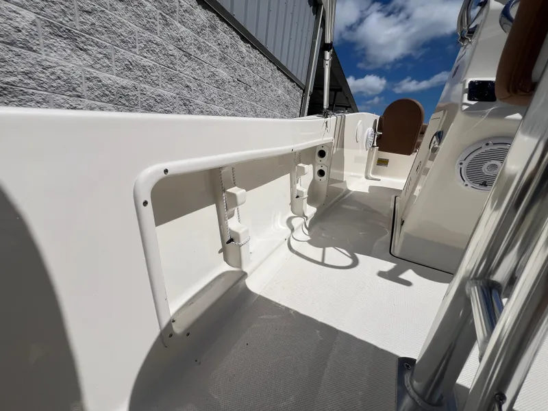 Slide: The Image of 2026 Pioneer 180 Islander boat interior, featuring sleek design and modern amenities under a clear sky. - 23