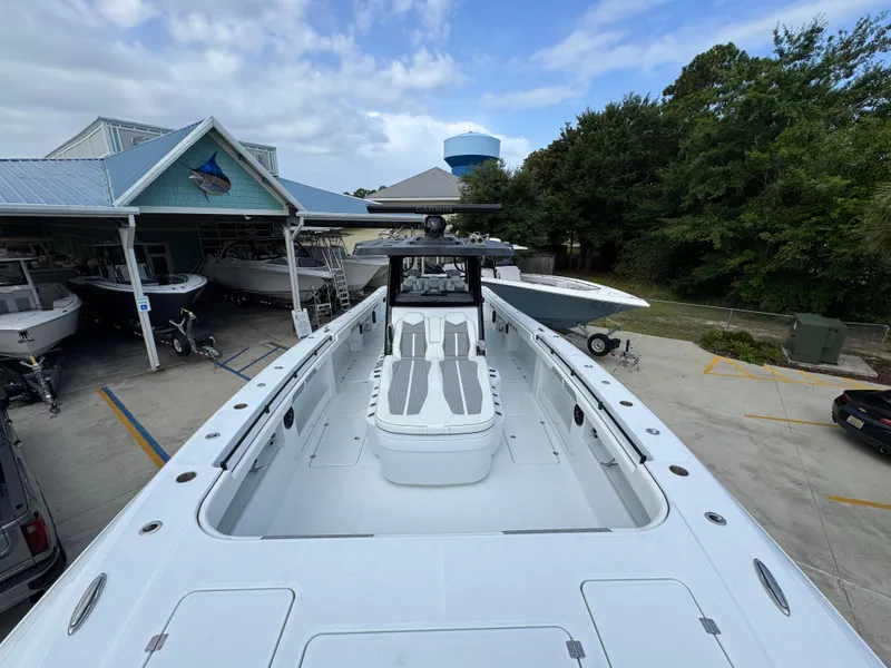 Slide: The Image of 2026 Invincible 46 Catamaran docked at a marina, showcasing spacious deck and sleek design. - 20