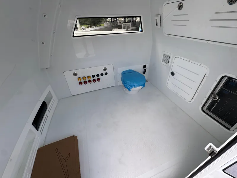 Slide: The Image of Interior of 2026 Invincible 46 Catamaran with control panel and covered seat. - 24