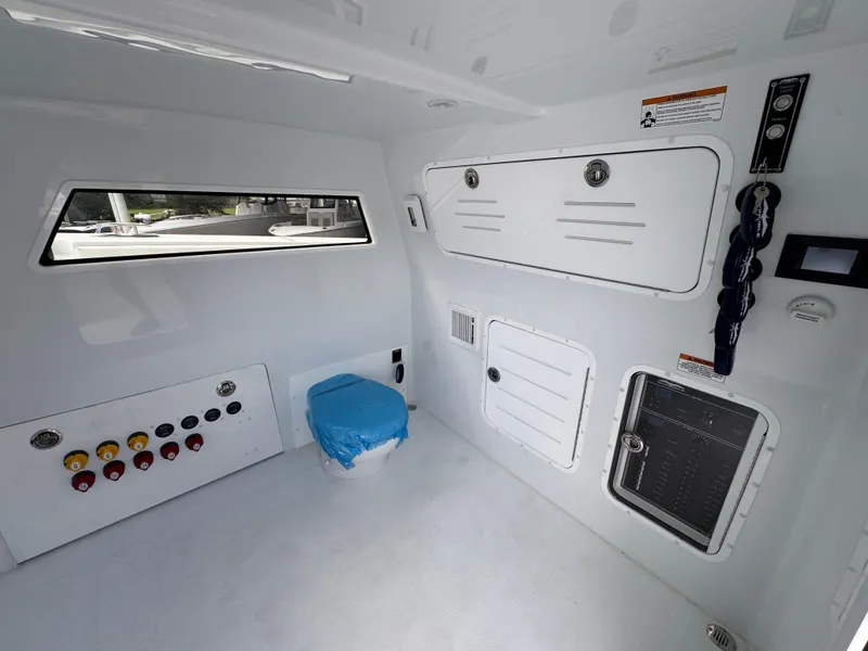 Slide: The Image of Interior of 2026 Invincible 46 Catamaran featuring control panels and storage compartments. - 25