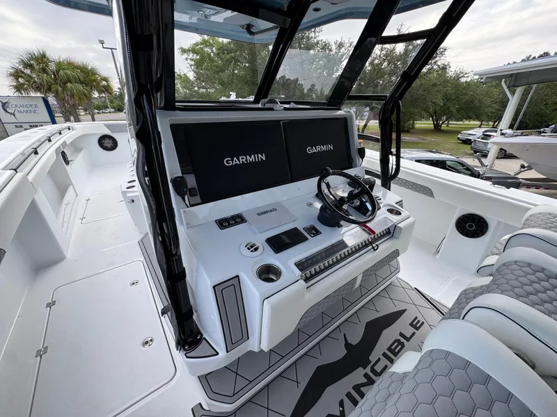 Slide: The Image of 2026 Invincible 46 Catamaran cockpit with Garmin displays and modern steering console. - 29
