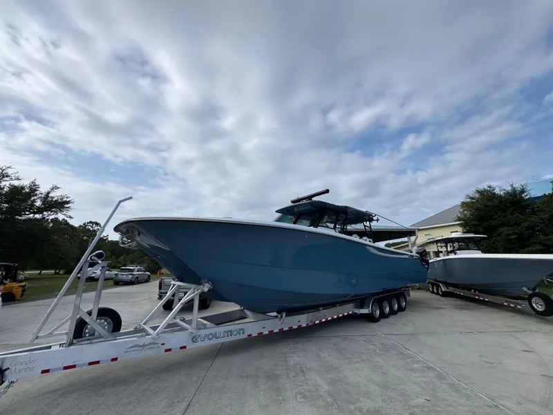 Slide: The Image of 2026 Invincible 46 Catamaran on trailer under cloudy sky, parked outdoors. - 3