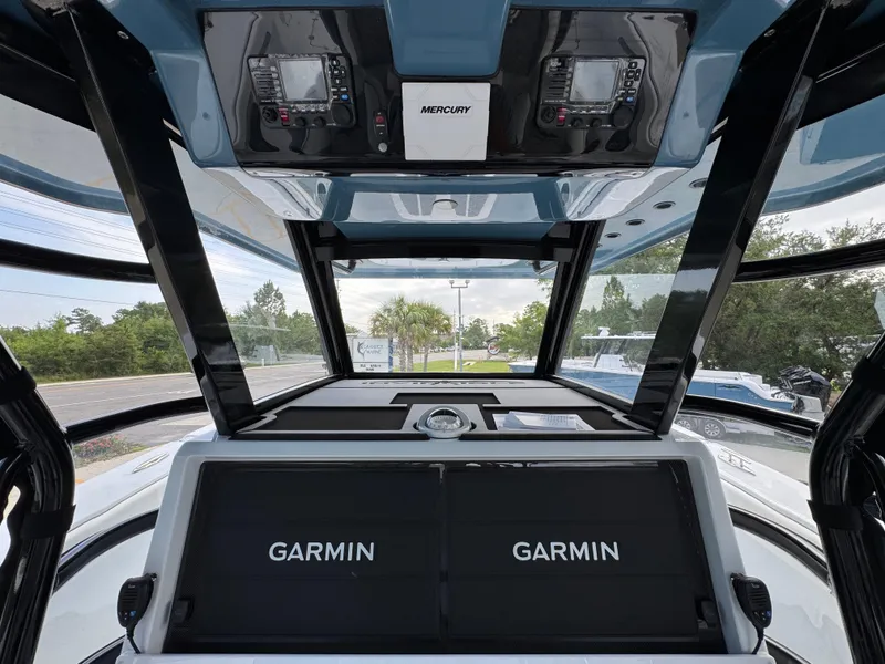 Slide: The Image of 2026 Invincible 46 Catamaran cockpit with Garmin navigation displays and Mercury controls. - 31