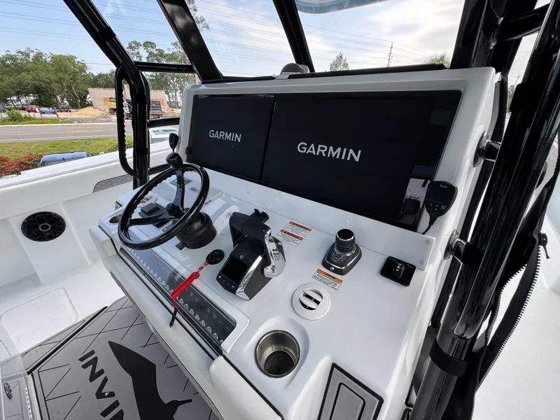 Slide: The Image of Helm of 2026 Invincible 46 Catamaran featuring dual Garmin displays and modern controls. - 32