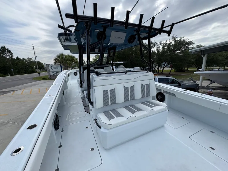 Slide: The Image of 2026 Invincible 46 Catamaran with sleek seating and modern design, docked outdoors. - 34