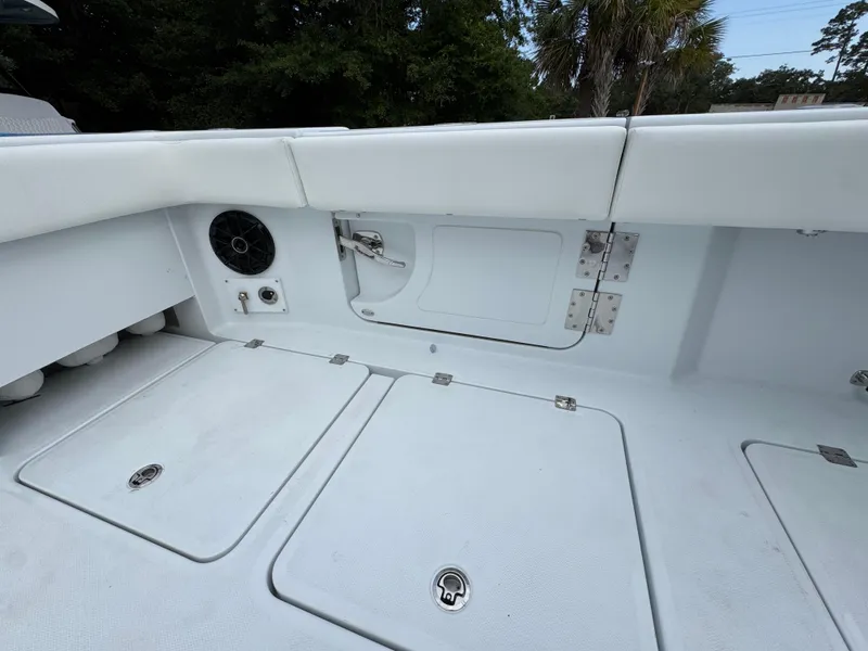 Slide: The Image of Interior view of 2026 Invincible 46 Catamaran, featuring storage compartments and seating. - 36