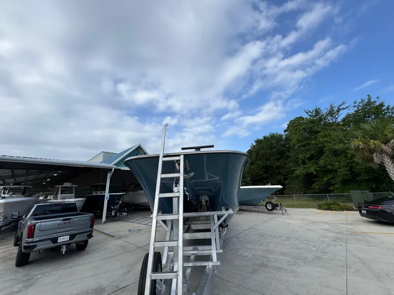 Slide: The Image of 2026 Invincible 46 Catamaran on trailer, parked outdoors under cloudy sky. - 6