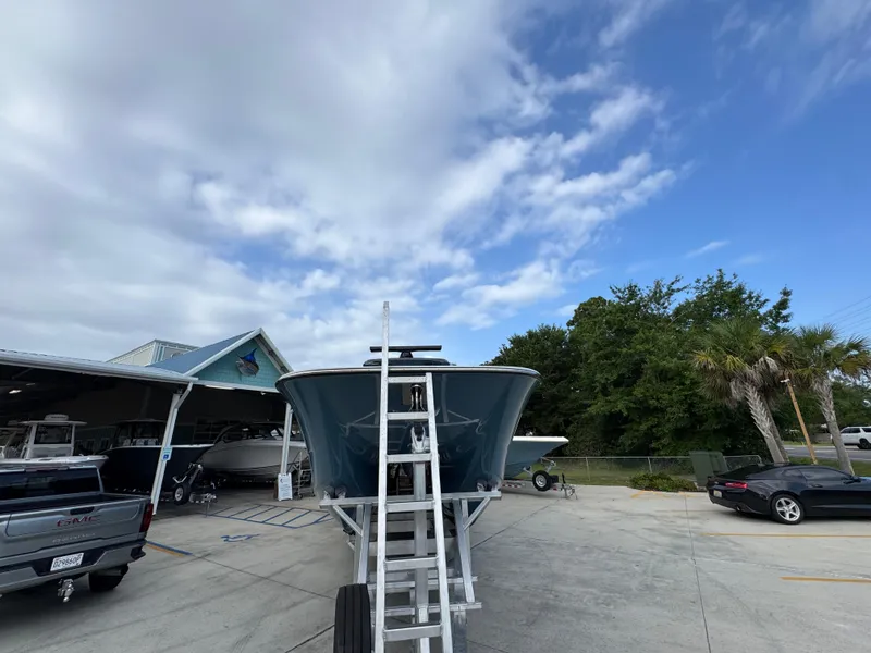 Slide: The Image of 2026 Invincible 46 Catamaran on trailer at marina, under partly cloudy sky. - 7