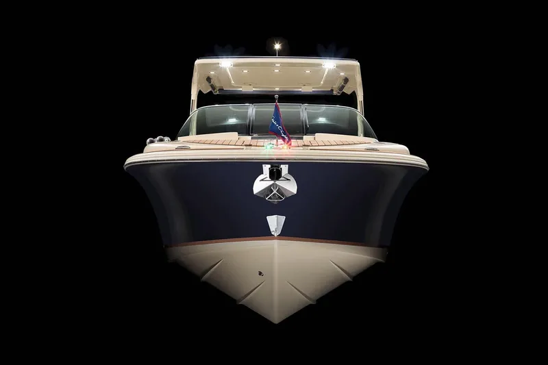 Slide: The Image of Manufacturer Provided Image: 2023 Chris-Craft Launch 31 GT boat, front view, illuminated against a black background. - 3