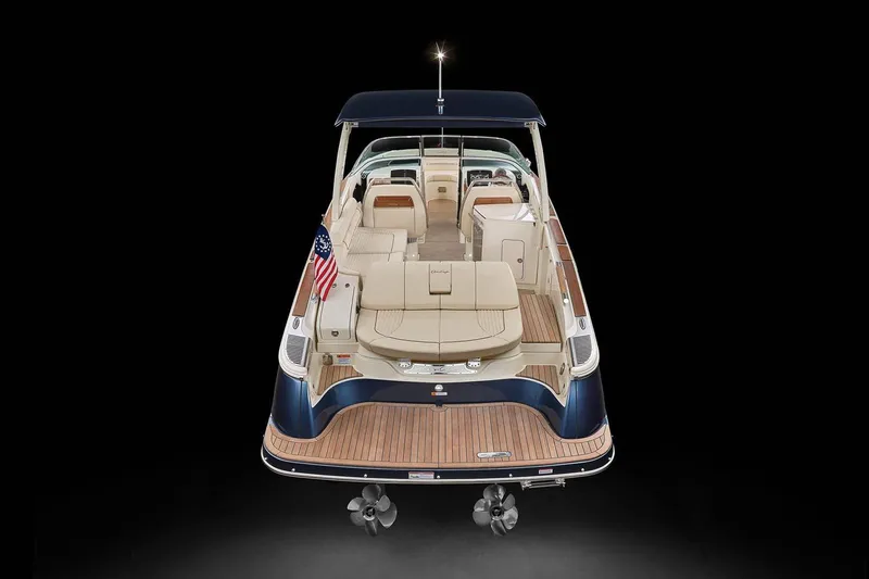Slide: The Image of Manufacturer Provided Image: 2023 Chris-Craft Launch 31 GT luxury boat, rear view with elegant seating and American flag. - 4