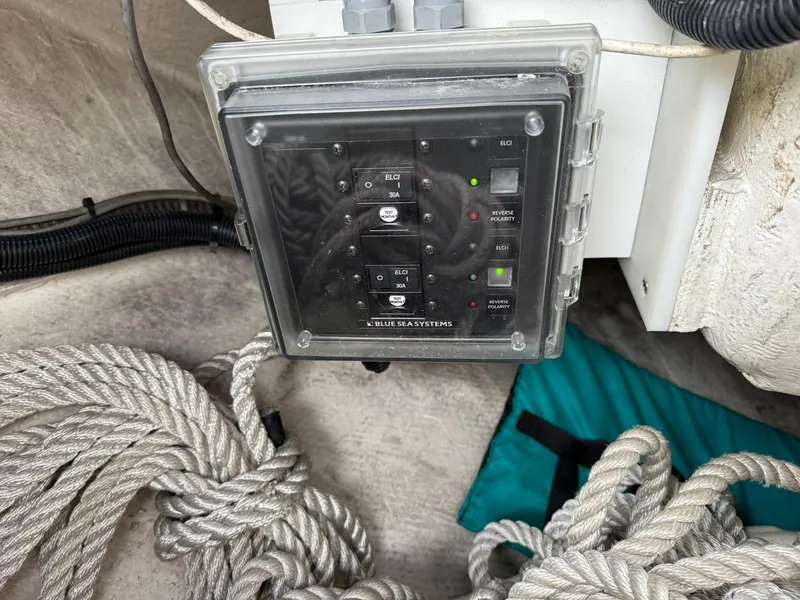 Slide: The Image of Electrical panel on a 2000 Catalina 36 MkII sailboat with coiled rope nearby. - 14