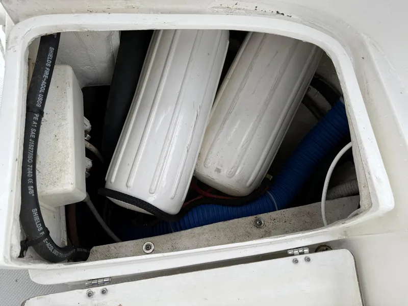 Slide: The Image of Storage compartment with hoses and equipment on a 2000 Catalina 36 MkII sailboat. - 15