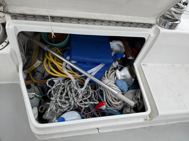 Slide: The Image of Storage compartment on a 2000 Catalina 36 MkII sailboat, filled with ropes and boating gear. - 17