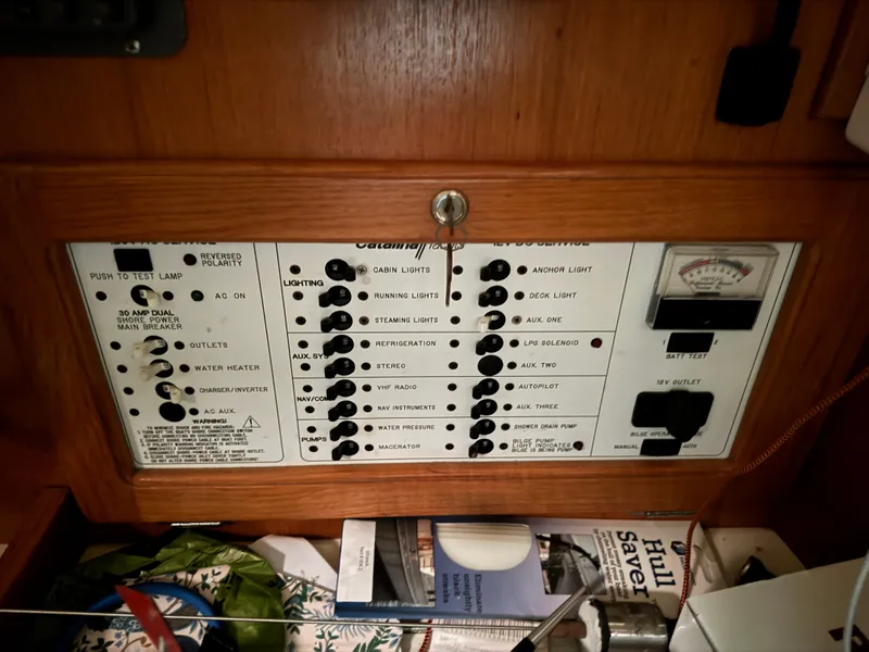 Slide: The Image of Electrical control panel of a 2000 Catalina 36 MkII sailboat, featuring various switches and gauges. - 25