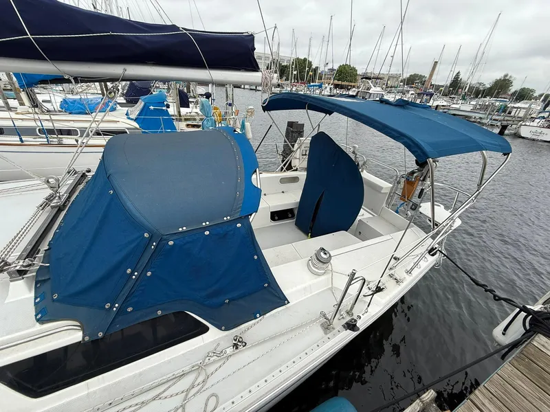 Slide: The Image of 2000 Catalina 36 MkII sailboat docked, featuring blue canvas covers and marina background. - 3