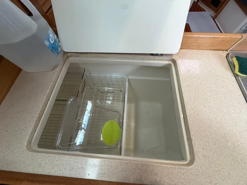 Slide: The Image of Built-in cooler on a 2000 Catalina 36 MkII sailboat, with a plastic container inside. - 35