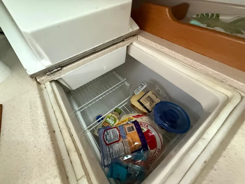 Slide: The Image of Refrigerator in 2000 Catalina 36 MkII yacht with assorted food items inside. - 36