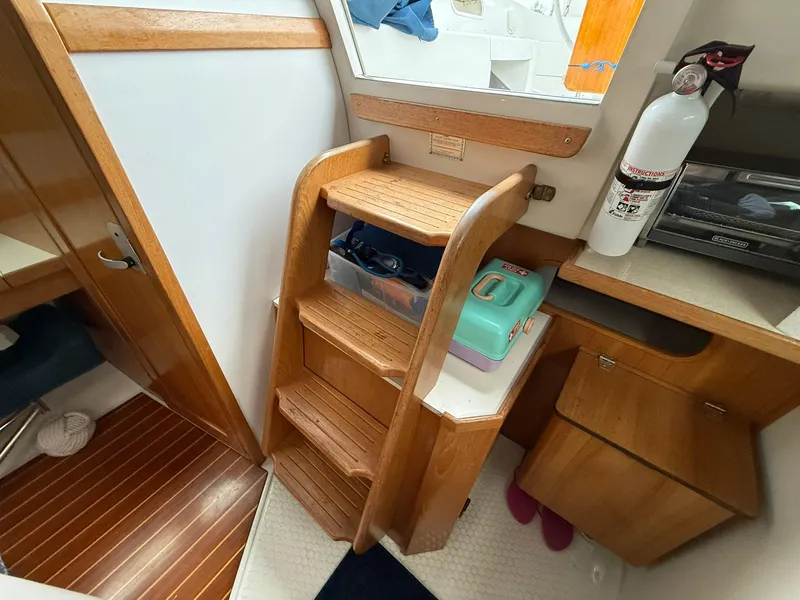 Slide: The Image of Interior of 2000 Catalina 36 MkII sailboat with wooden steps and fire extinguisher. - 38