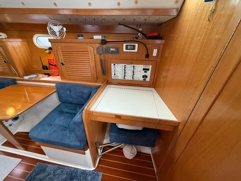 Slide: The Image of Interior of a 2000 Catalina 36 MkII sailboat with navigation station and seating area. - 39