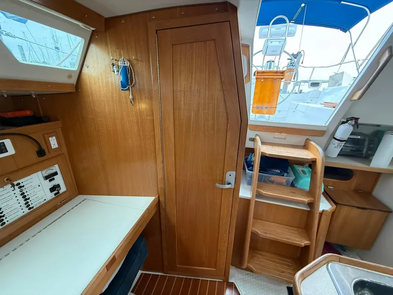 Slide: The Image of Interior of a 2000 Catalina 36 MkII sailboat with wooden cabinetry and navigation station. - 45