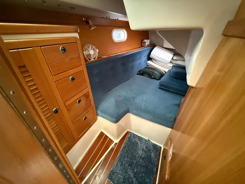 Slide: The Image of Cozy cabin interior of 2000 Catalina 36 MkII sailboat with wooden cabinetry and blue upholstery. - 46