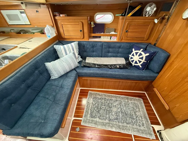 Slide: The Image of Cozy interior of a 2000 Catalina 36 MkII sailboat with blue seating and nautical decor. - 49