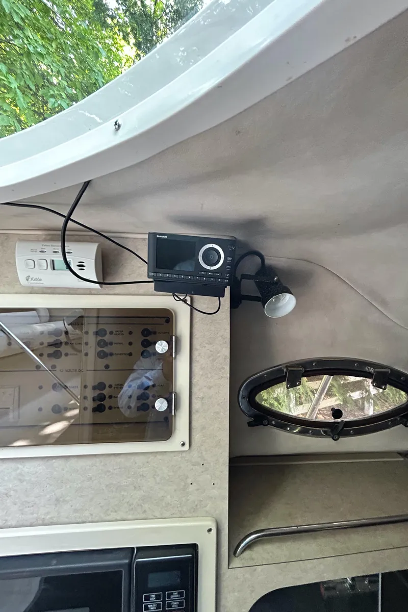 Slide: The Image of Interior of a 1995 Donzi 255 Medallion boat with control panel and electronics. - 13