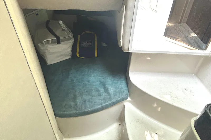 Slide: The Image of Interior cabin of a 1995 Donzi 255 Medallion boat with storage bags. - 14
