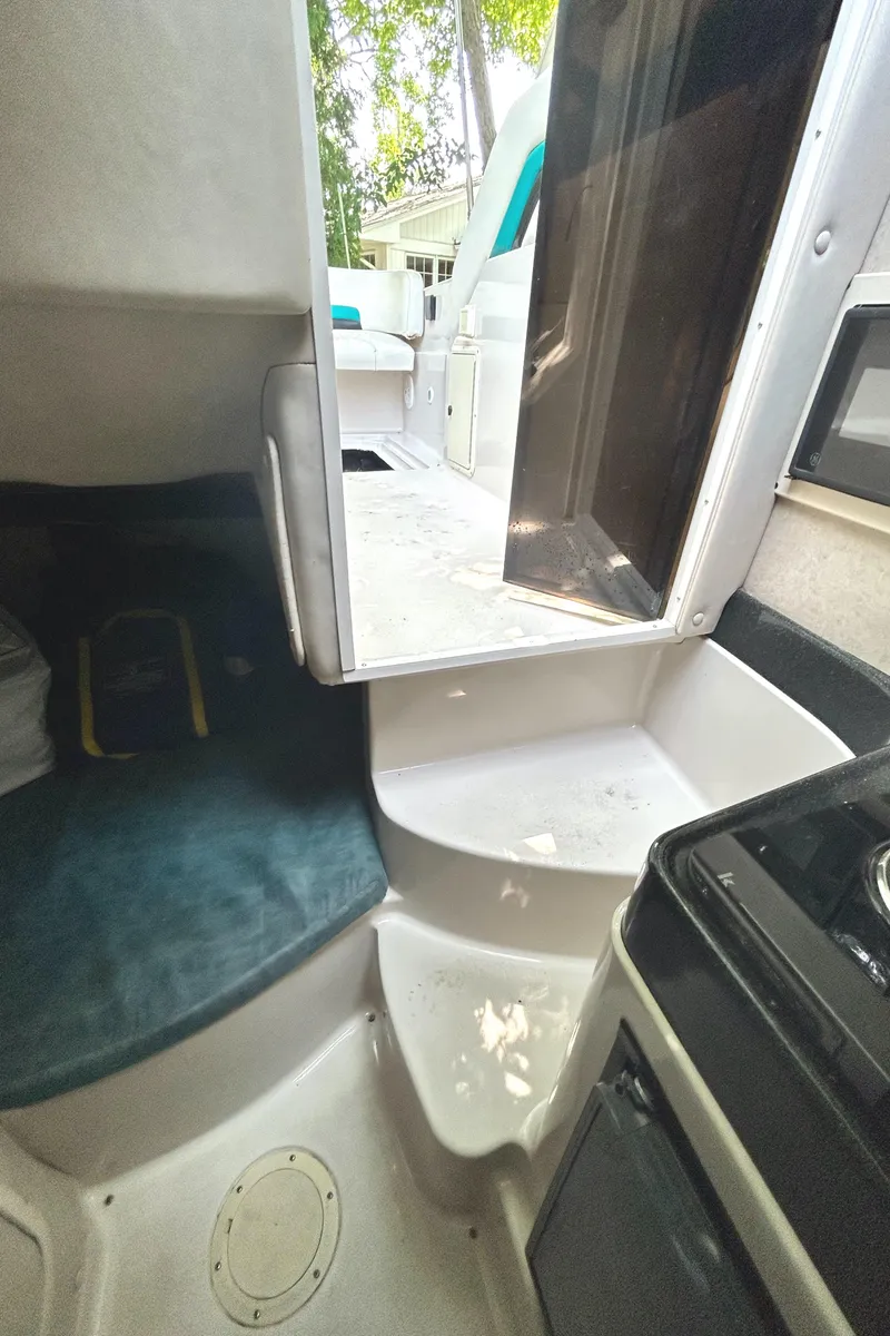 Slide: The Image of Interior cabin of a 1995 Donzi 255 Medallion boat with seating and steps. - 15