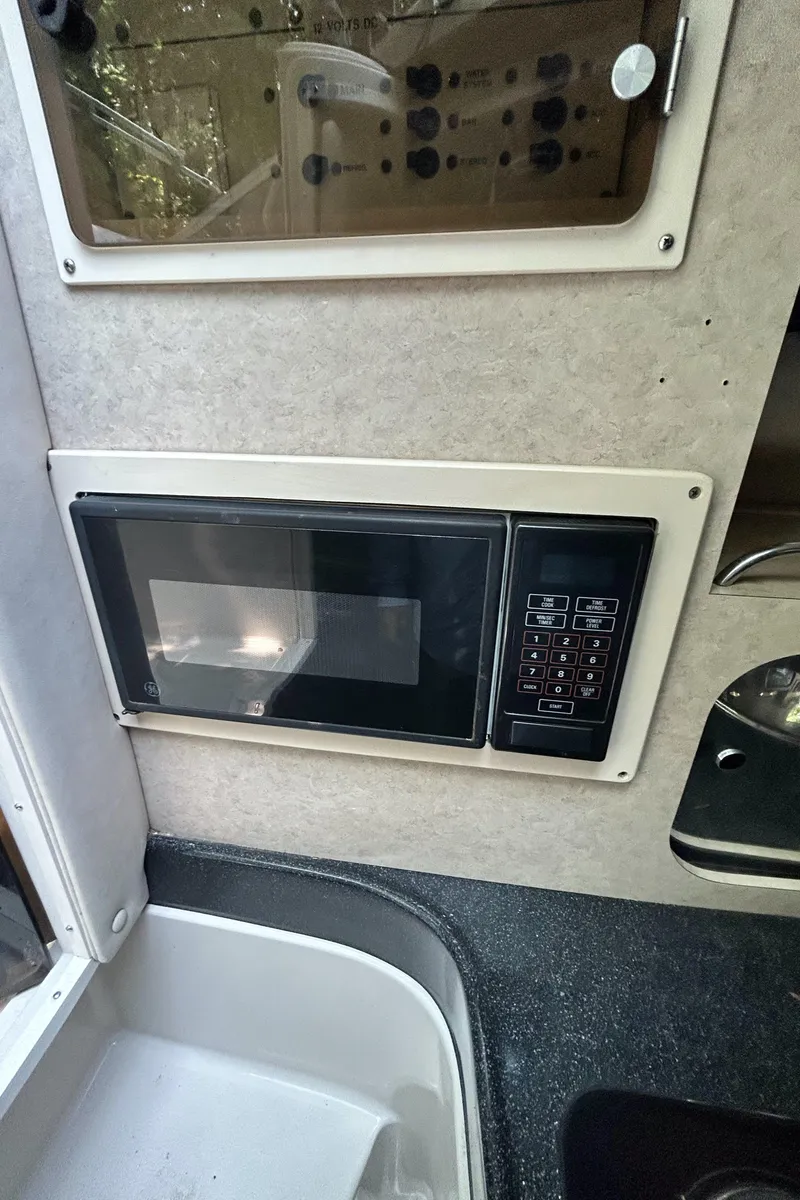 Slide: The Image of Microwave in the kitchen area of a 1995 Donzi 255 Medallion boat. - 16
