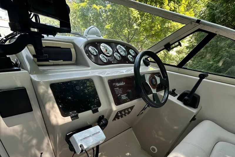 Slide: The Image of 1995 Donzi 255 Medallion boat cockpit with steering wheel and instrument panel. - 2