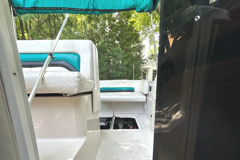 Slide: The Image of 1995 Donzi 255 Medallion boat interior with white and teal seating. - 7
