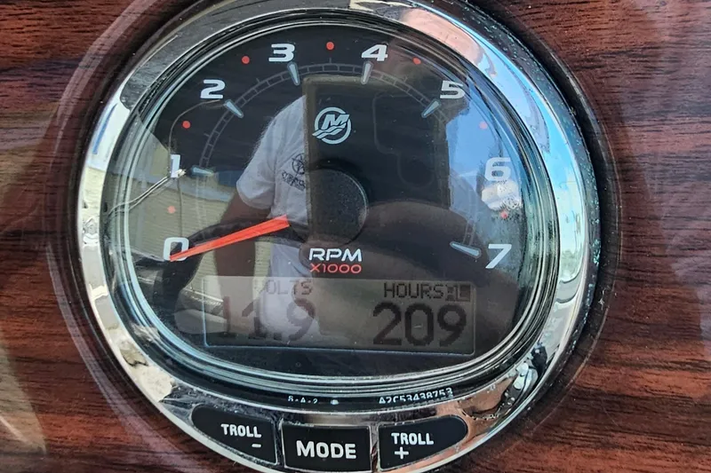 Slide: The Image of Close-up of a 2005 Sea Ray 220 Sundeck RPM gauge showing 209 hours. - 11