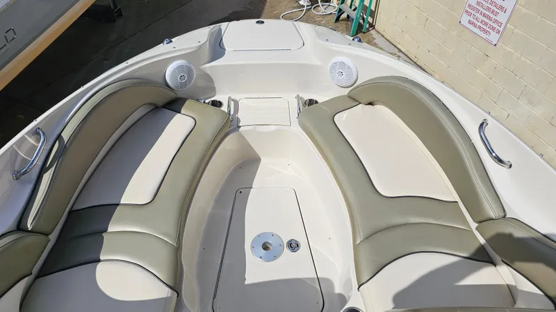 Slide: The Image of 2005 Sea Ray 220 Sundeck boat interior with cushioned seating and speakers. - 14