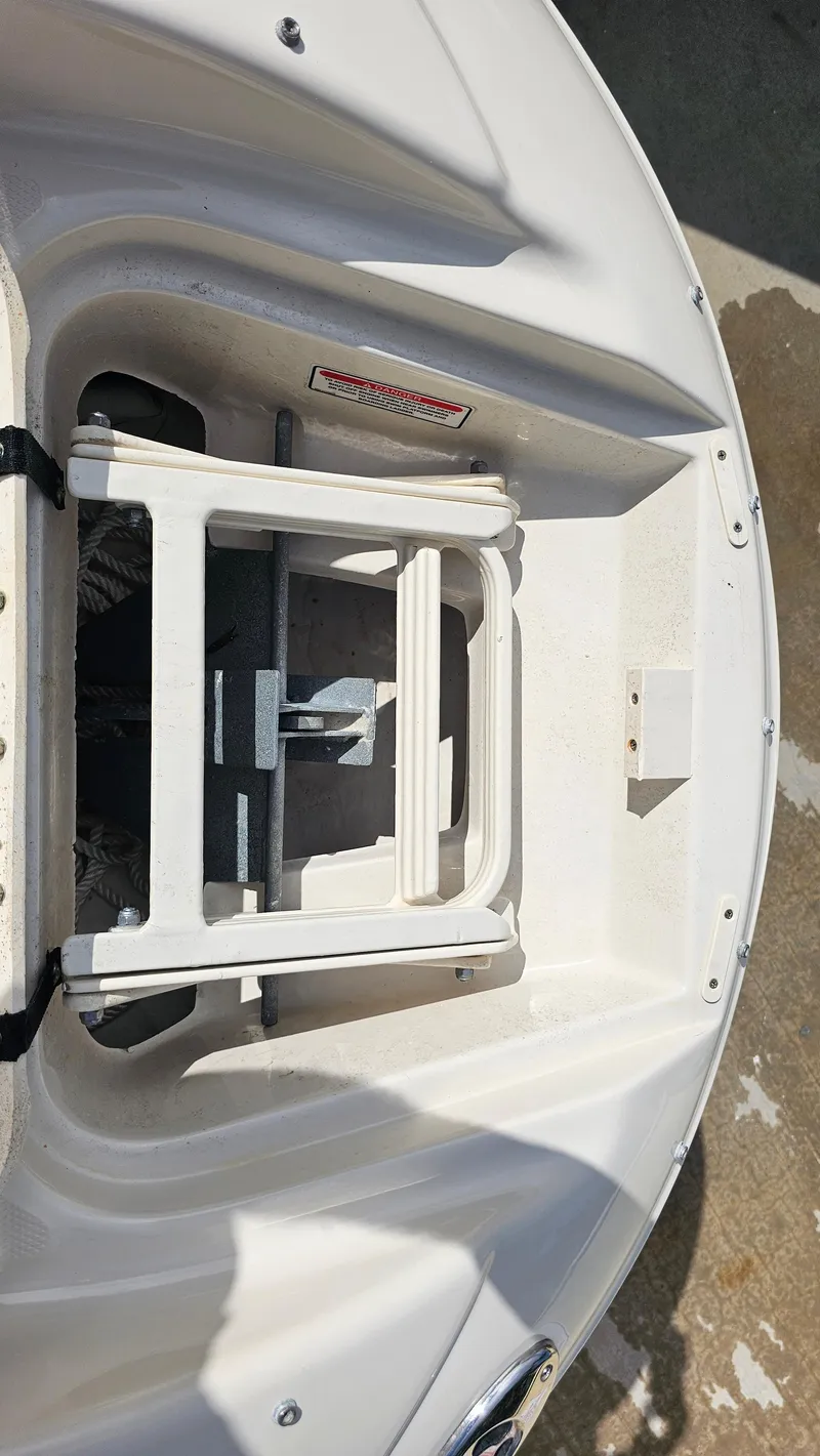 Slide: The Image of 2005 Sea Ray 220 Sundeck boat anchor compartment with ladder, viewed from above. - 15