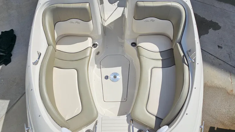 Slide: The Image of 2005 Sea Ray 220 Sundeck boat interior with beige seating and stainless steel accents. - 16