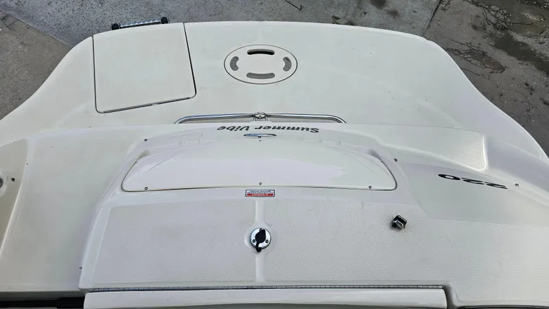 Slide: The Image of 2005 Sea Ray 220 Sundeck boat deck, featuring storage compartments and sleek design. - 21